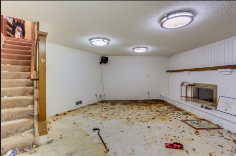 Living room before cleaning, with debris across the floor